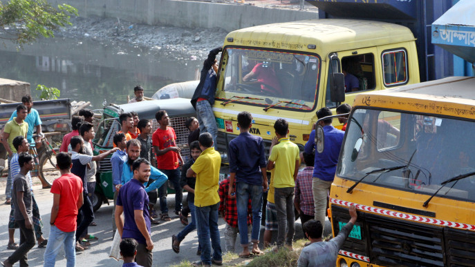 Strikers are seen stopping vehicles on the road on Chattogram's Bisshwa Road area